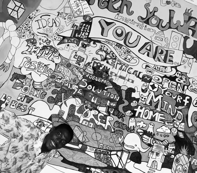 Close detail of the mural's hand-painted lettering reading “open your mind” and “you are”.